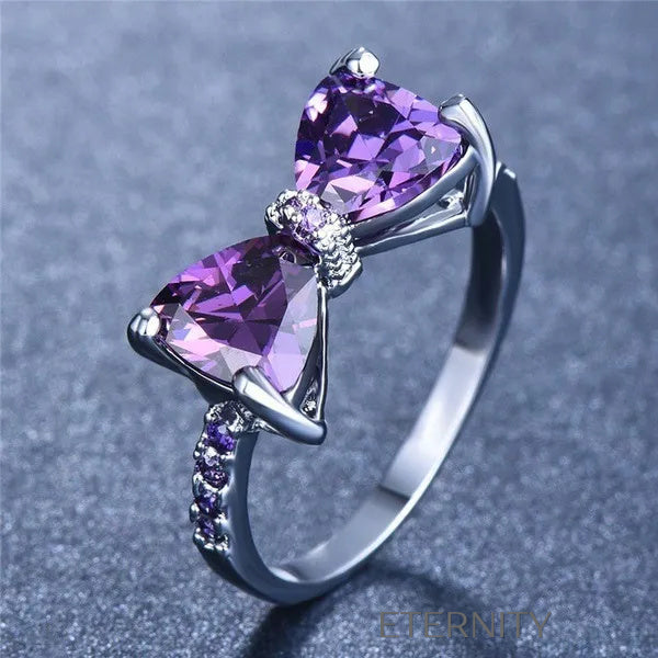 Anillo Amethyst Bow de Lazo con Cristales Violetas y Banda Empedrada  Anillos Purpura 7 Acero Inoxidable  ETERNITY