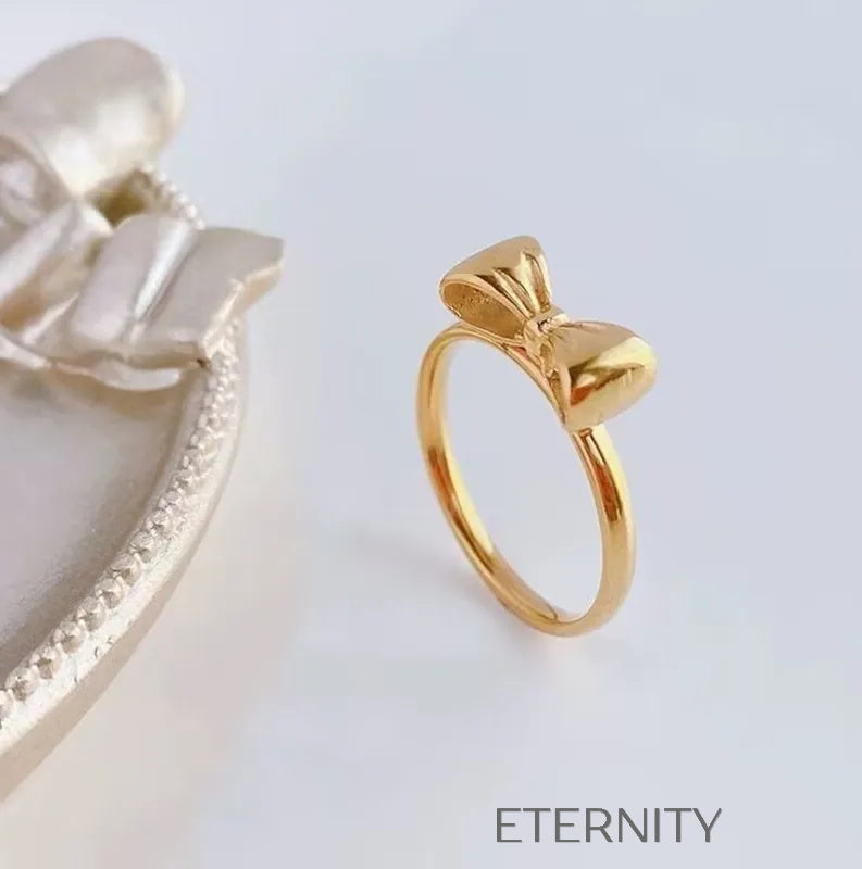 Anillo Fino Sweet Bow con Diseño de Lazo en Oro Pulido  Anillos Dorado 7 Acero Inoxidable  ETERNITY
