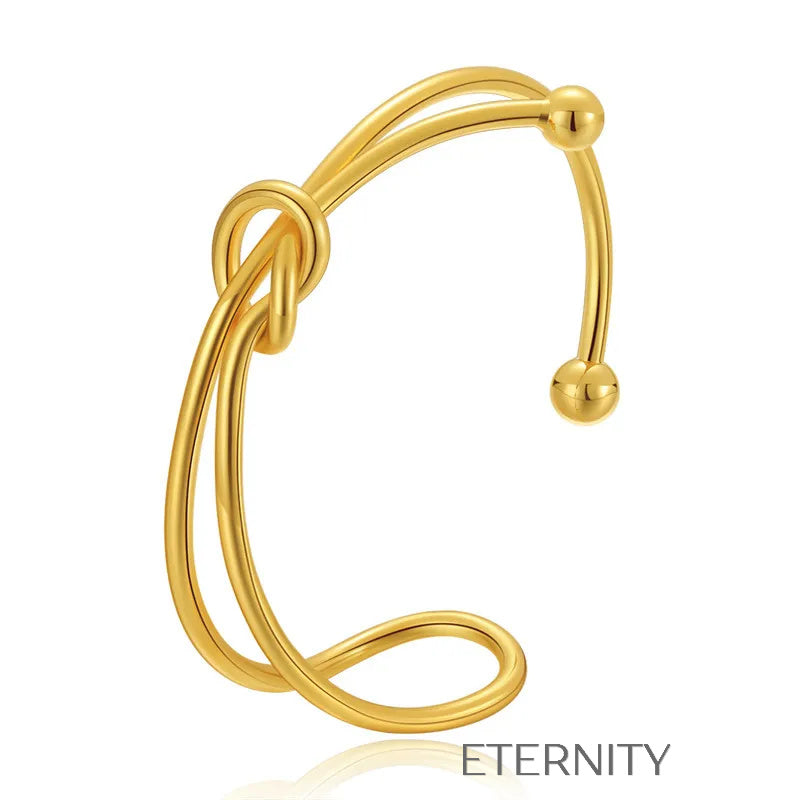 Brazalete Rígido Knot con Nudo Central en Oro  Brazaletes Dorado Unica Acero Inoxidable  ETERNITY