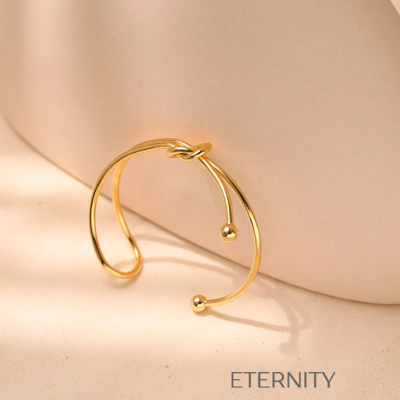 Brazalete Rígido Knot con Nudo Central en Oro  Brazaletes Dorado Unica Acero Inoxidable  ETERNITY