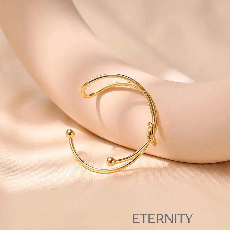 Brazalete Rígido Knot con Nudo Central en Oro  Brazaletes Dorado Unica Acero Inoxidable  ETERNITY
