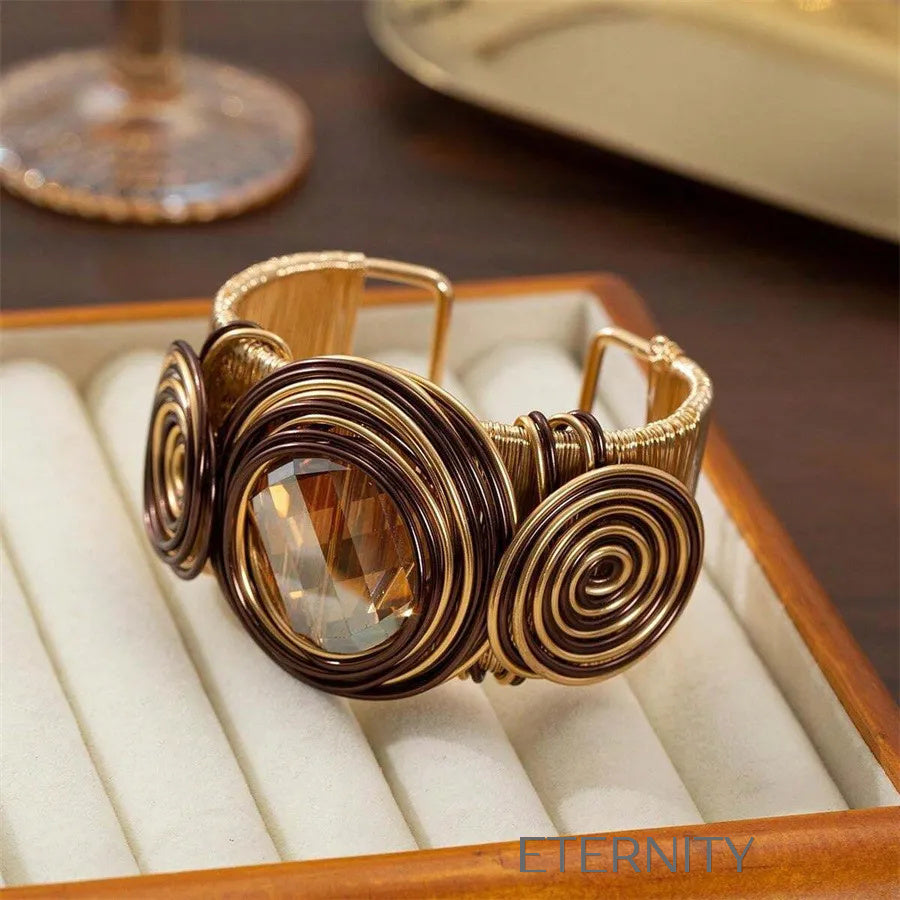 Brazalete Ethereal Spiral de Alambre Dorado y Piedra Central  Brazaletes Negro Unica Acero Inoxidable  ETERNITY