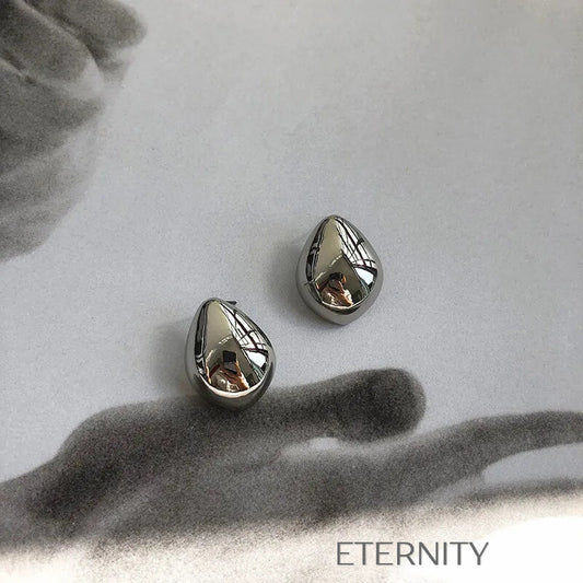 Zarcillos Gota Escultórica  Zarcillos Dorado Unica Acero Inoxidable  ETERNITY