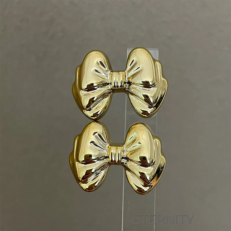 Zarcillos Moño Gloss  Zarcillos Dorado Unica Acero Inoxidable  ETERNITY