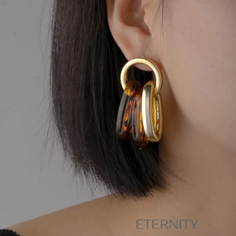 Zarcillos de Aros Entrelazados en Oro y Resina Carey  Zarcillos Dorado Unica Acero Inoxidable  ETERNITY