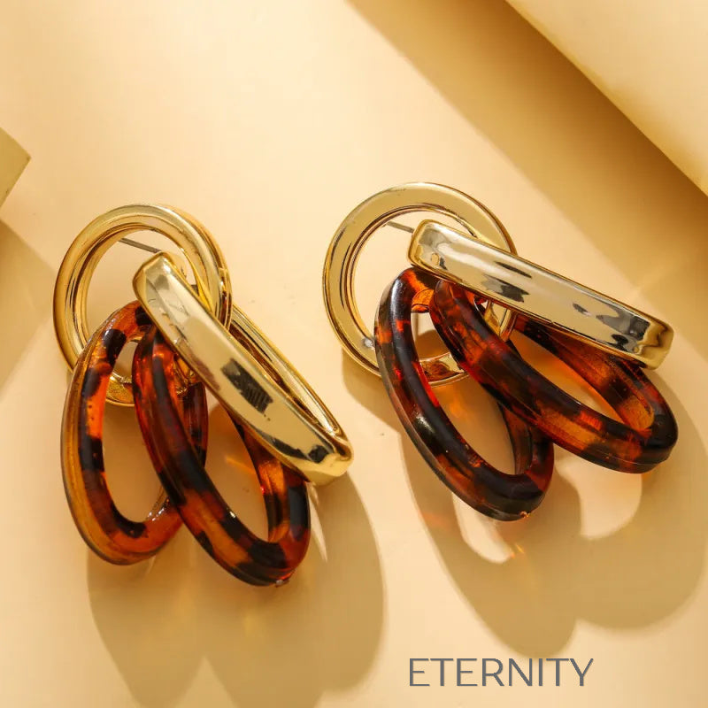 Zarcillos de Aros Entrelazados en Oro y Resina Carey  Zarcillos Dorado Unica Acero Inoxidable  ETERNITY