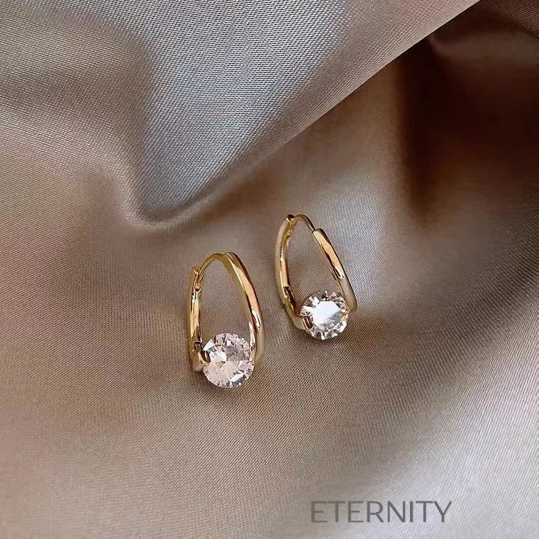 Zarcillos Solitaire Aura de Aro Estilizado con Cristal Central en Oro y Plata  Zarcillos Dorado Unica Acero Inoxidable  ETERNITY