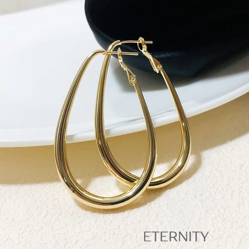 Zarcillos Oval Essence  Zarcillos Dorado Unica Acero Inoxidable  ETERNITY