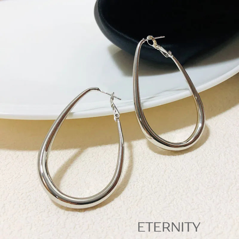 Zarcillos Oval Essence  Zarcillos Dorado Unica Acero Inoxidable  ETERNITY