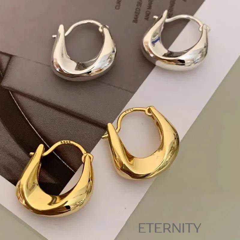 Aretes dorados tipo aro con diseño escultórico moderno Zarcillos Dorado Unica Acero Inoxidable  ETERNITY
