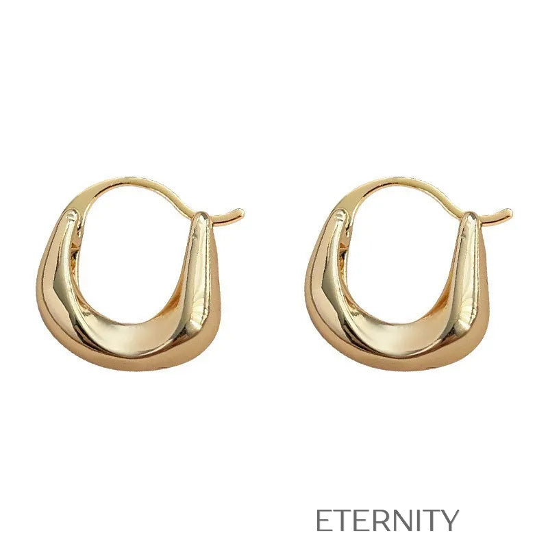 Aretes dorados tipo aro con diseño escultórico moderno Zarcillos Dorado Unica Acero Inoxidable  ETERNITY