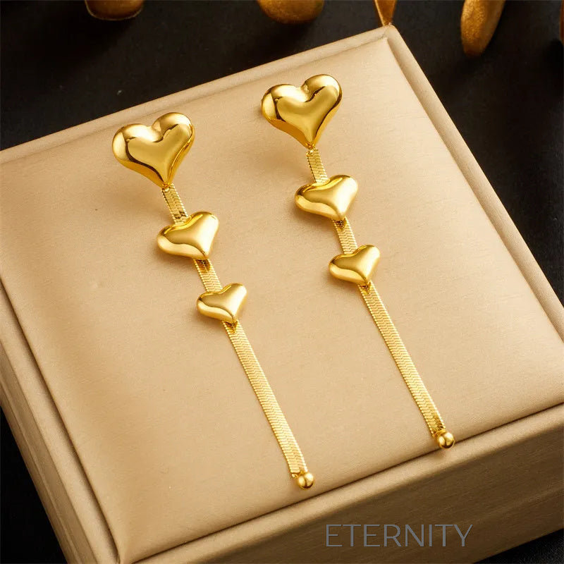 Zarcillos Largos Luminous Heart con Cascada de Corazones y Cadena Plana  Zarcillos Dorado Unica Acero Inoxidable  ETERNITY
