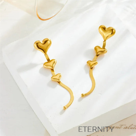 Zarcillos Largos Luminous Heart con Cascada de Corazones y Cadena Plana  Zarcillos Dorado Unica Acero Inoxidable  ETERNITY