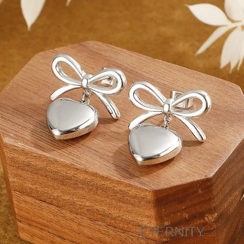 Zarcillos Coquette Heart de Lazo y Corazón  Zarcillos Dorado Unica Acero Inoxidable  ETERNITY