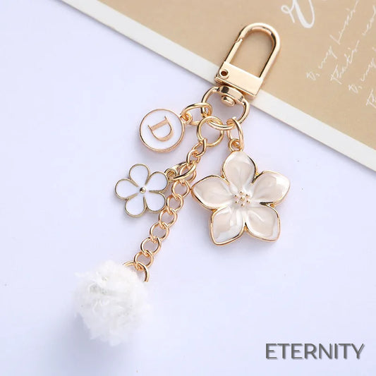 Llaveros Adorables con Flores Esmaltadas, Letra y Pompón - ETERNITY