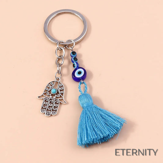Llavero Plateado con Ojo Turco, Mano de Hamsa Calada y Borla Azul - ETERNITY